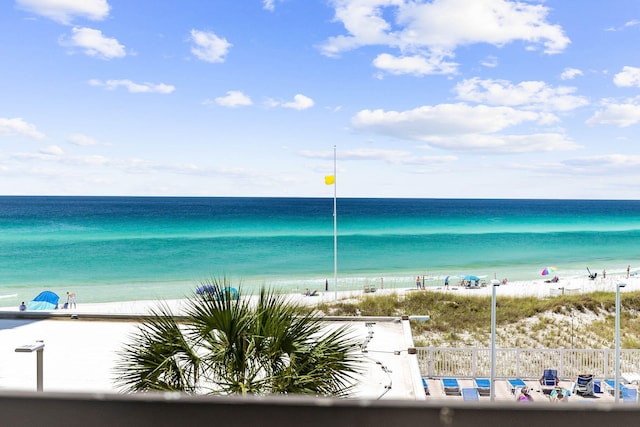 view of water feature with a view of the beach and fence