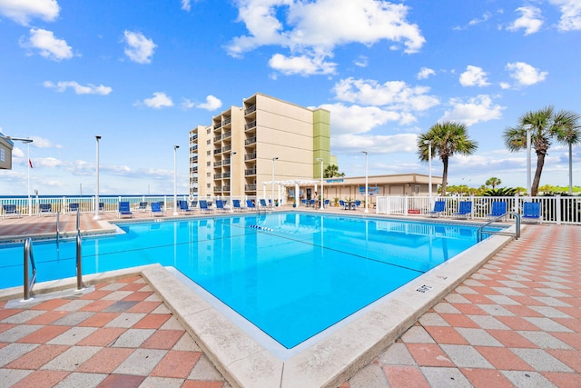 pool featuring a patio and fence