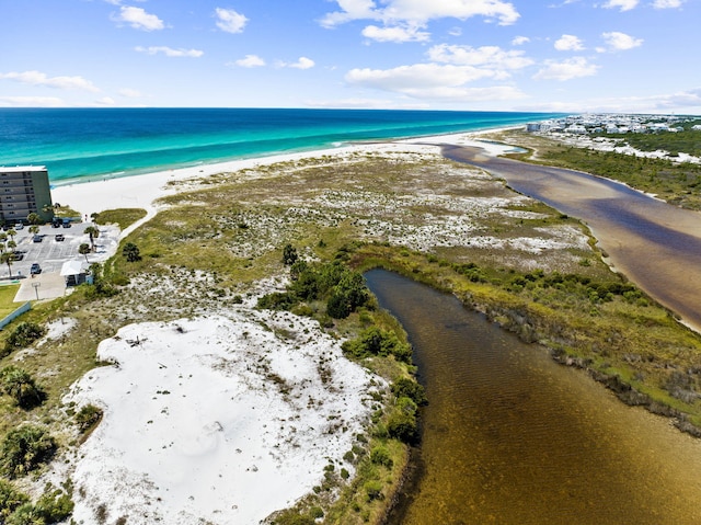 birds eye view of property with a beach view and a water view