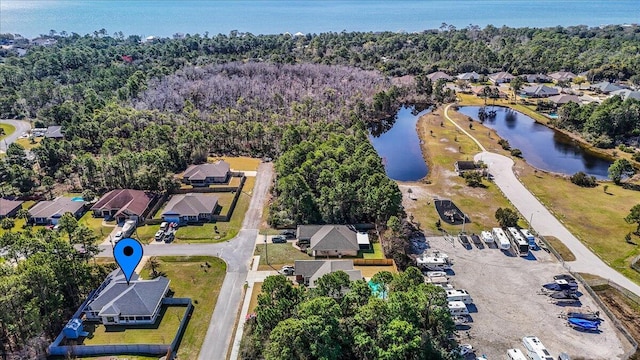 drone / aerial view featuring a water view and a residential view