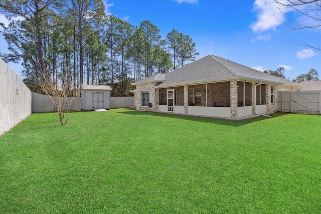 back of property with an outbuilding, brick siding, a fenced backyard, and a storage shed