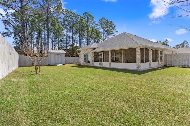 rear view of property with brick siding, a shed, an outbuilding, and a fenced backyard