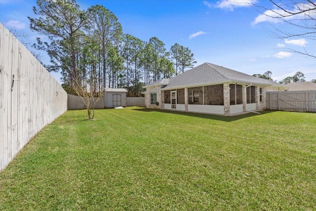 view of yard with an outbuilding, a sunroom, a fenced backyard, and a shed