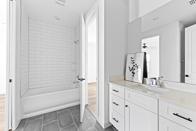 full bathroom with vanity, bathtub / shower combination, visible vents, and a ceiling fan