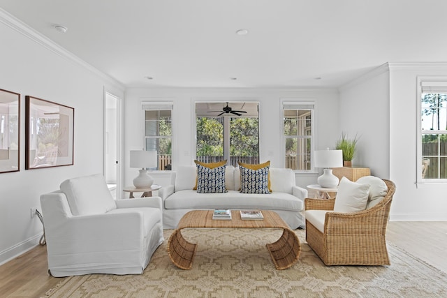 living room with wood finished floors, baseboards, and ornamental molding