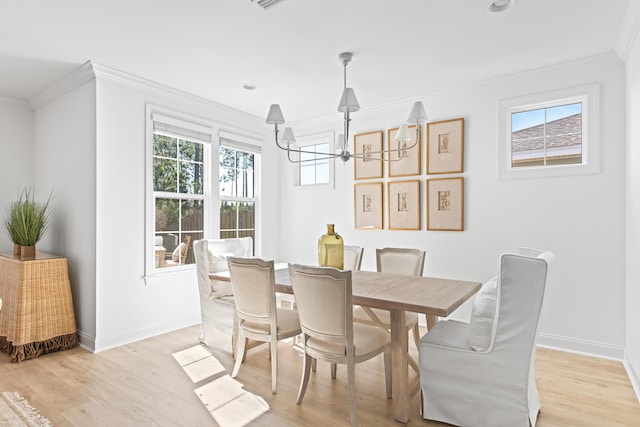 dining area featuring an inviting chandelier, light wood-style flooring, crown molding, and a healthy amount of sunlight