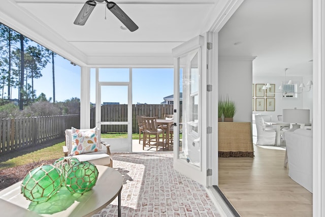 sunroom / solarium featuring ceiling fan