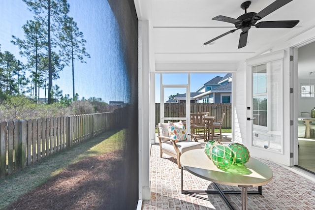 sunroom / solarium with plenty of natural light and ceiling fan