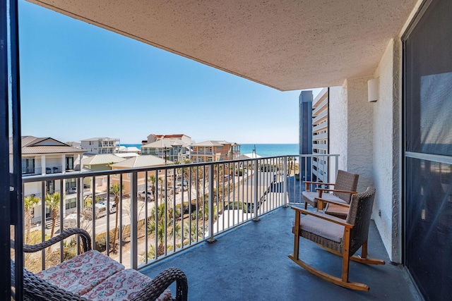 balcony featuring a water view