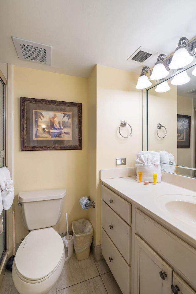 bathroom with visible vents, toilet, vanity, and tile patterned flooring