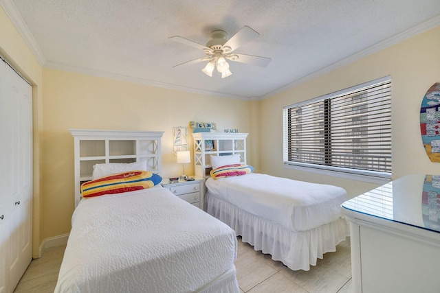 bedroom with a textured ceiling, ornamental molding, and a ceiling fan