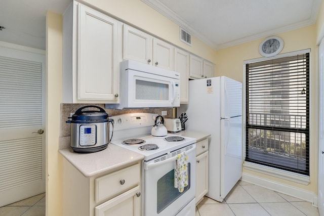 kitchen featuring light tile patterned floors, visible vents, white appliances, and crown molding