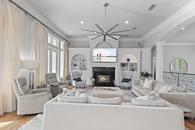 2940 Pine Valley Dr, Miramar Beach, FL 32550 - living room featuring ornamental molding, light wood-style flooring, a ceiling fan, visible vents, and ornate columns