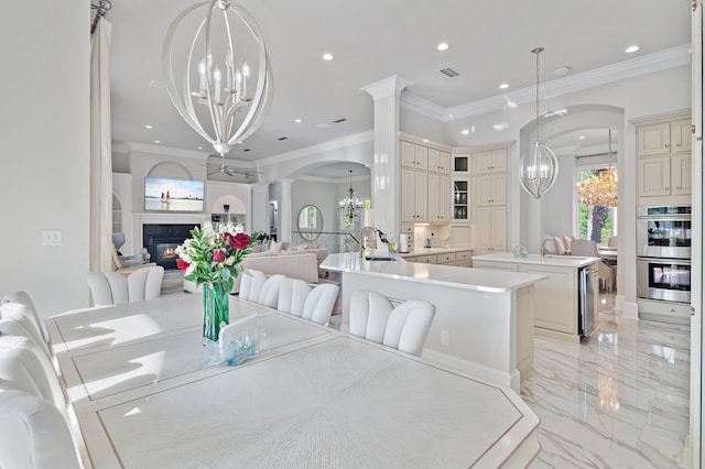 2940 Pine Valley Dr, Miramar Beach, FL 32550 - dining area featuring crown molding, arched walkways, recessed lighting, marble finish floor, and a notable chandelier