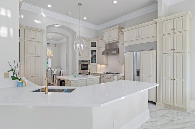 2940 Pine Valley Dr, Miramar Beach, FL 32550 - kitchen featuring cream cabinetry, wall chimney exhaust hood, stainless steel oven, and a notable chandelier