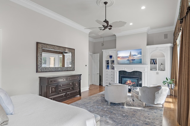 2940 Pine Valley Dr, Miramar Beach, FL 32550 - bedroom with baseboards, a high end fireplace, crown molding, recessed lighting, and wood finished floors
