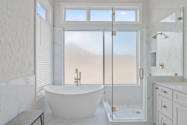 2940 Pine Valley Dr, Miramar Beach, FL 32550 - bathroom featuring tile walls, a soaking tub, vanity, a marble finish shower, and marble finish floor