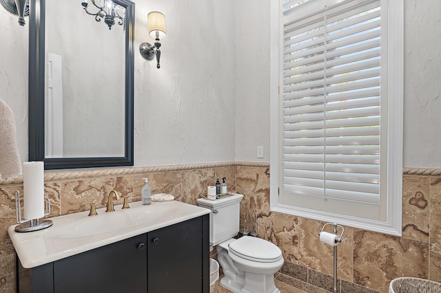 2940 Pine Valley Dr, Miramar Beach, FL 32550 - bathroom featuring vanity, a wainscoted wall, toilet, and a healthy amount of sunlight
