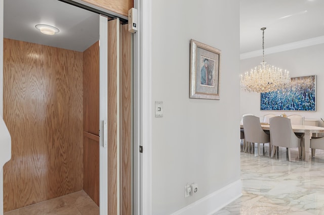 2940 Pine Valley Dr, Miramar Beach, FL 32550 - hall with baseboards, elevator, an inviting chandelier, ornamental molding, and marble finish floor