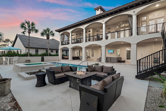 2940 Pine Valley Dr, Miramar Beach, FL 32550 - patio terrace at dusk featuring a fenced in pool, a balcony, an in ground hot tub, an outdoor living space with a fire pit, and ceiling fan