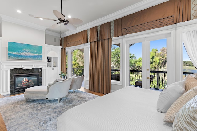 2940 Pine Valley Dr, Miramar Beach, FL 32550 - bedroom featuring crown molding, access to exterior, multiple windows, and a glass covered fireplace