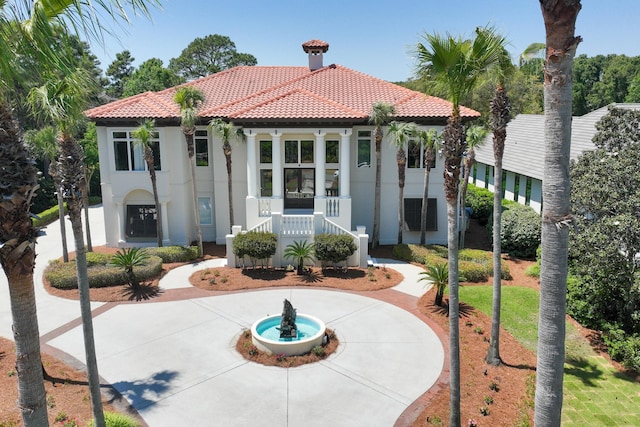 2940 Pine Valley Dr, Miramar Beach, FL 32550 - view of front of home featuring a porch, a tile roof, curved driveway, and stucco siding