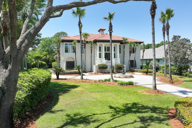 2940 Pine Valley Dr, Miramar Beach, FL 32550 - mediterranean / spanish home featuring a tile roof, a chimney, a front yard, and stucco siding