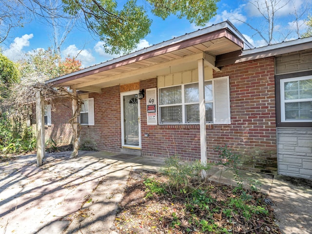 entrance to property with brick siding