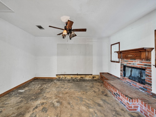 unfurnished living room with visible vents, unfinished concrete flooring, baseboards, a fireplace, and a ceiling fan