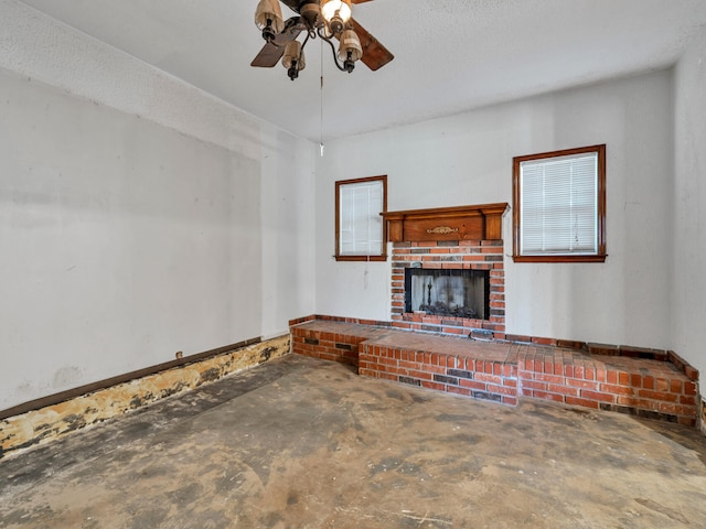 unfurnished living room featuring a fireplace, ceiling fan, and unfinished concrete floors