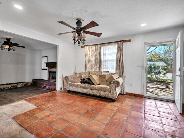 living area featuring a healthy amount of sunlight, a textured ceiling, and ceiling fan