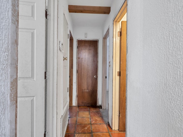 hall with tile patterned floors