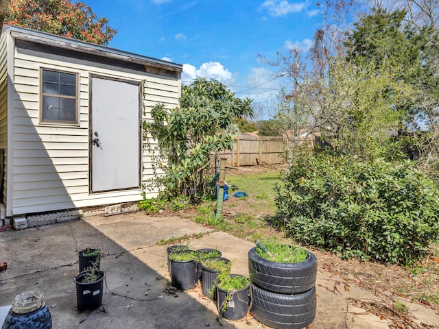 view of shed featuring fence