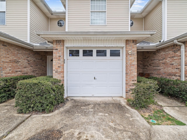 garage featuring concrete driveway