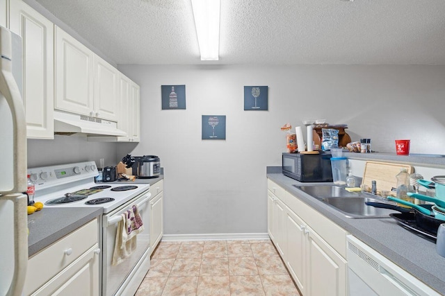 kitchen featuring white appliances, a sink, white cabinets, under cabinet range hood, and a textured ceiling