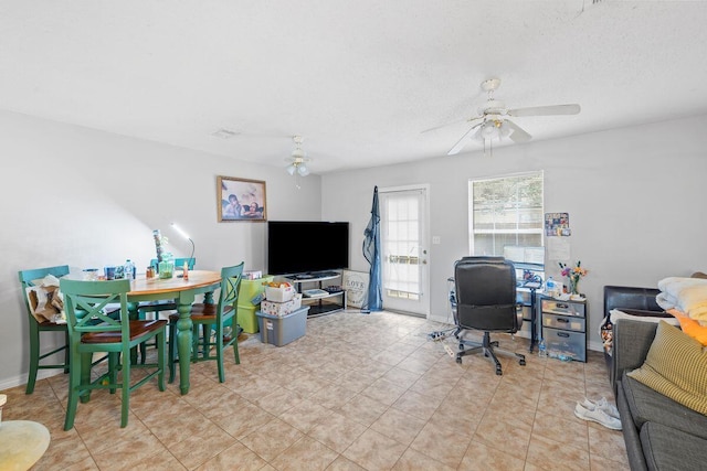 interior space with light tile patterned flooring, a textured ceiling, and ceiling fan