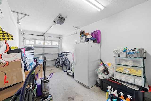 garage featuring a garage door opener and freestanding refrigerator