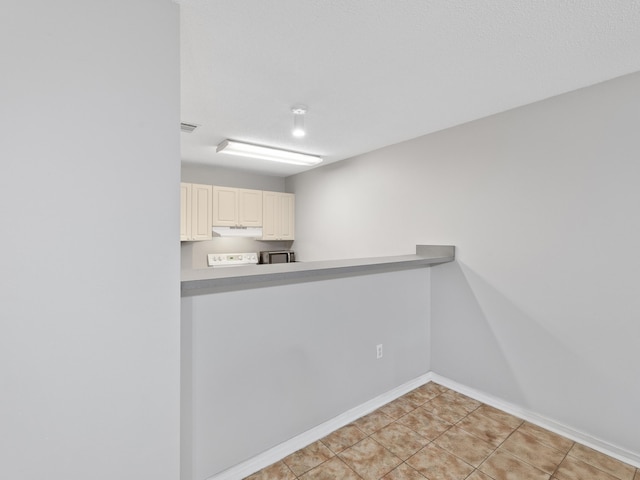 interior space featuring light tile patterned floors and baseboards