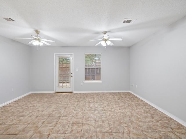 spare room with visible vents, baseboards, and a ceiling fan