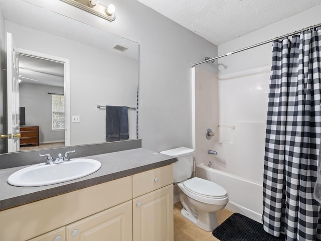 full bathroom with visible vents, shower / tub combo with curtain, toilet, a textured ceiling, and vanity