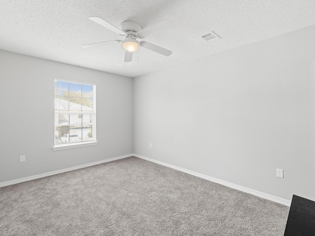 unfurnished room featuring visible vents, baseboards, a textured ceiling, and ceiling fan