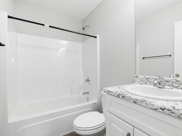 full bath featuring vanity, toilet, tub / shower combination, and a textured ceiling