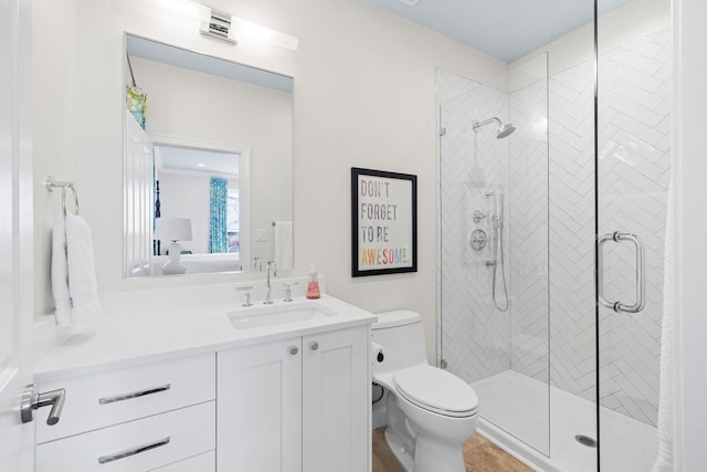 ensuite bathroom with vanity, a shower stall, toilet, and connected bathroom