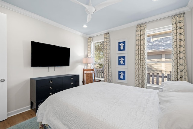 bedroom featuring recessed lighting, wood finished floors, baseboards, and ornamental molding