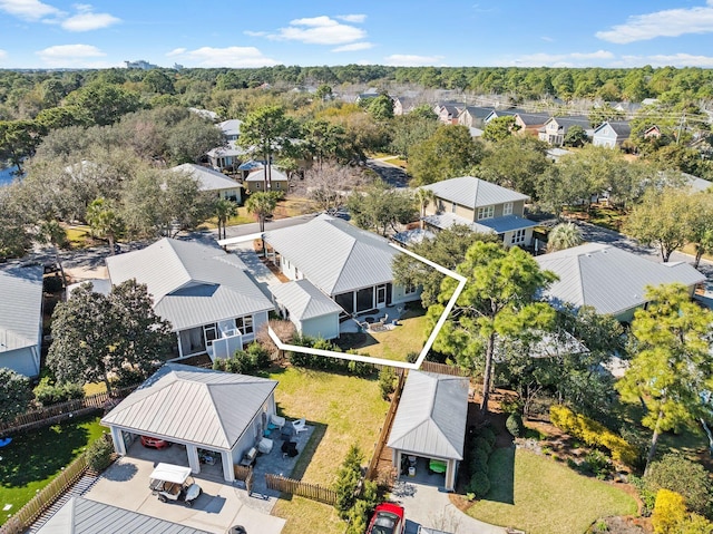 drone / aerial view featuring a forest view and a residential view