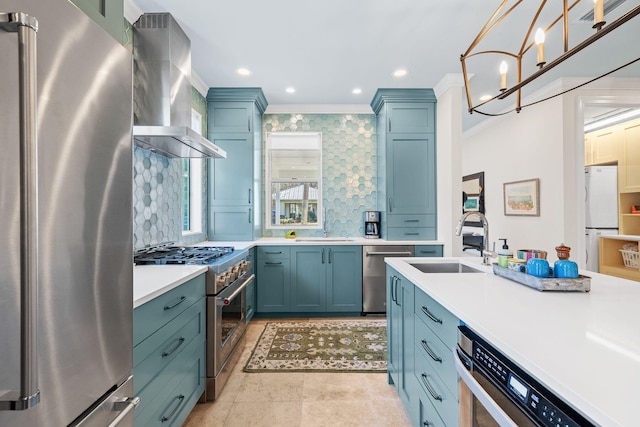 kitchen featuring a sink, stainless steel appliances, ornamental molding, and wall chimney range hood