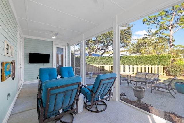 sunroom featuring a ceiling fan