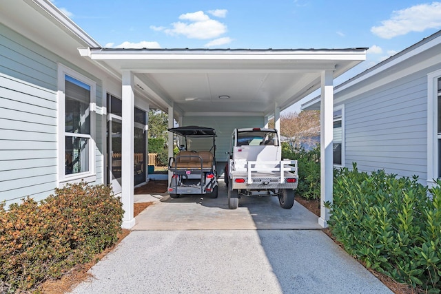 view of parking with an attached carport and concrete driveway