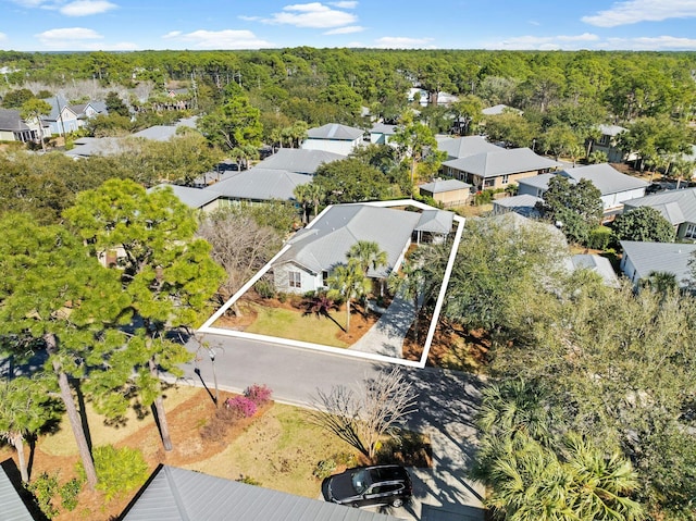 drone / aerial view with a residential view and a wooded view