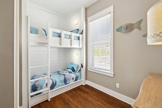 bedroom featuring baseboards and wood finished floors